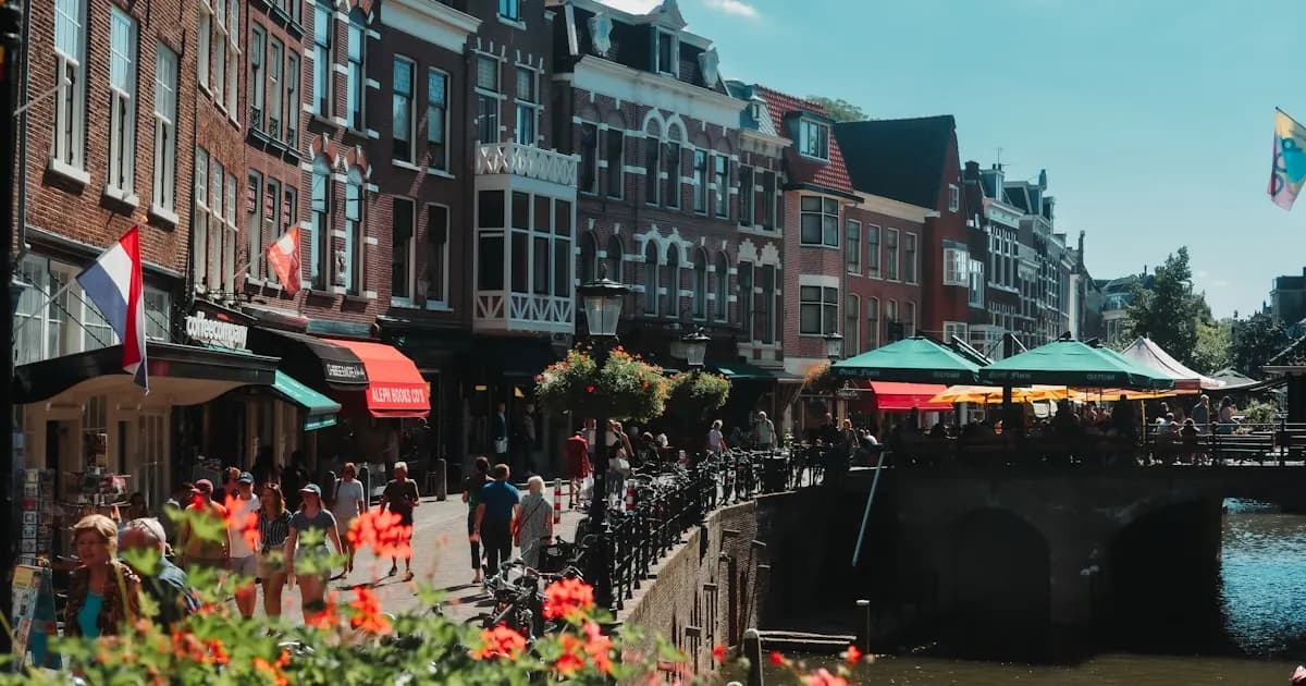 Utrecht canal with wharf cellars and Dom Tower in the background